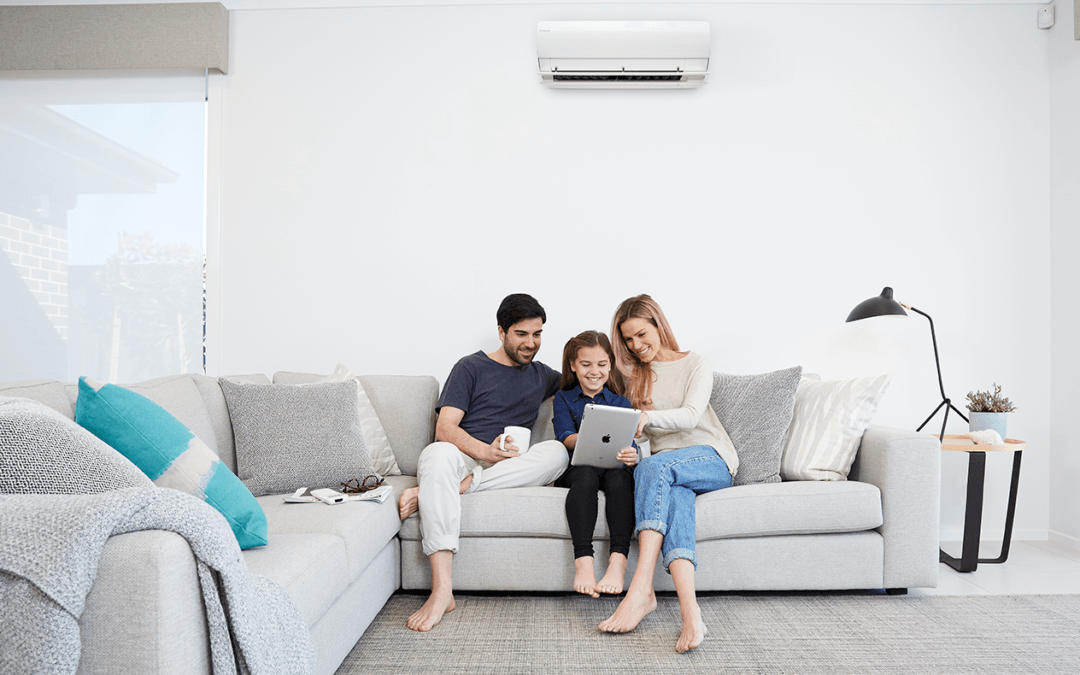 Family sitting on couch with ductless ac in austin texas