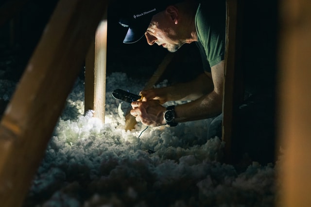 Man installing attic insulation in austin texas